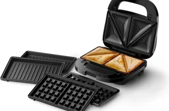 Schwarzer 3-in-1 Sandwichmaker mit gebräuntem Toast und drei austauschbaren Grillplatten auf weißem Hintergrund