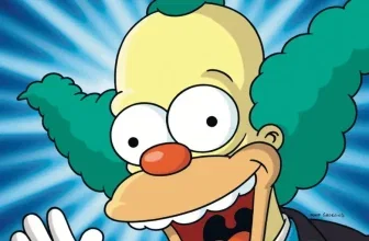 Krusty der Clown in einer übertriebenen Darstellung mit weit aufgerissenem Mund und herausgestreckter Zunge, im Hintergrund ein blauer Sternburst