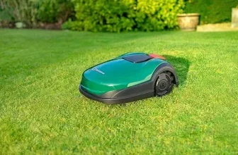 Ein grüner Rasenmähroboter liegt auf einem Rasen