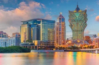 Skyline von Macau mit dem Grand Lisboa Hotel am Wasser bei Dämmerung