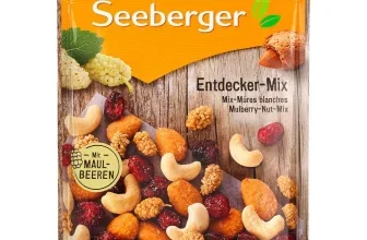 Seeberger Entdecker-Mix Beutel mit Cashews, Mandeln und getrockneten Früchten auf Holz